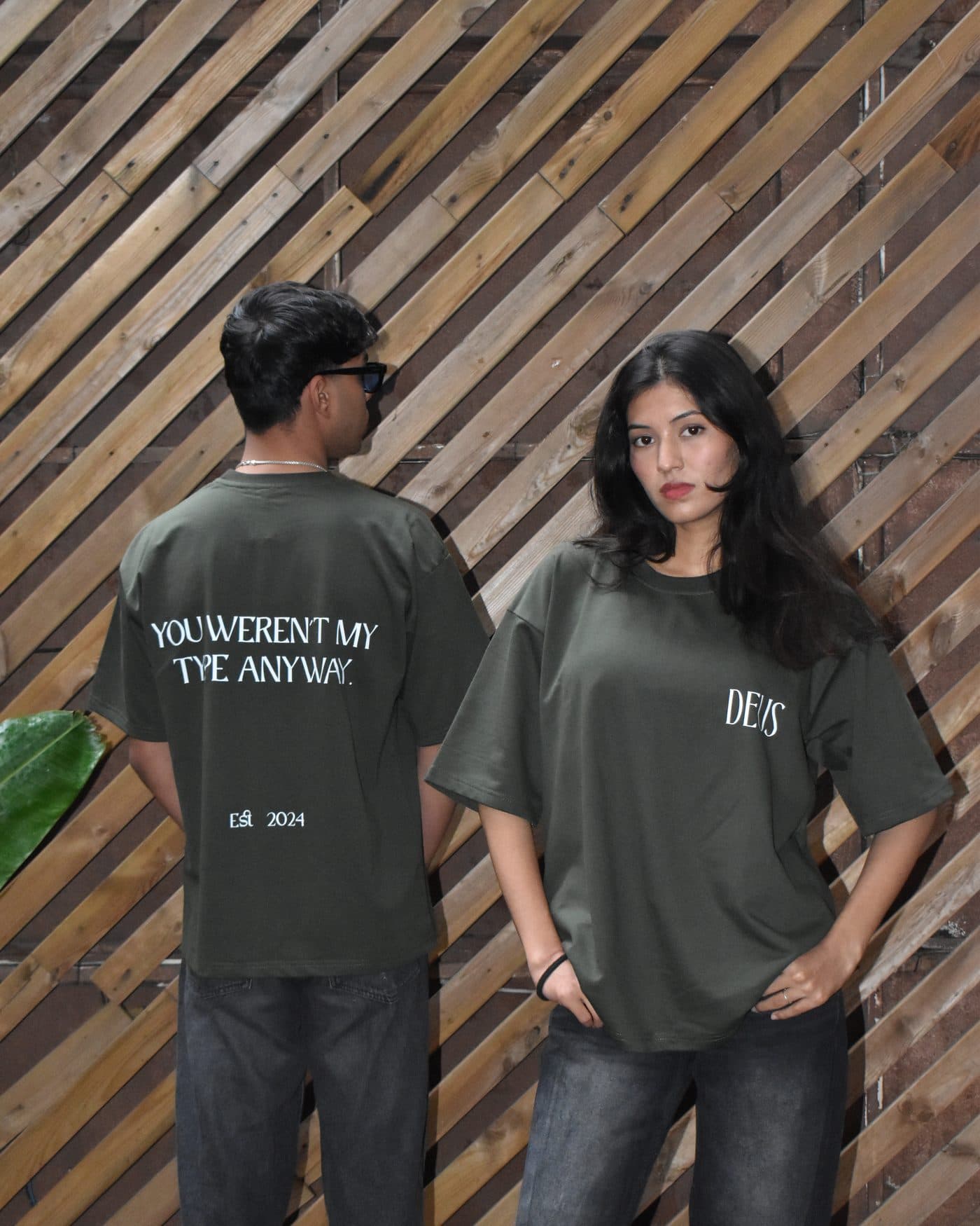 Model wearing the DEUS Type Anyway olive green oversized T-shirt, front, with DEUS chest logo